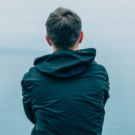 A man with his back apparently sad.