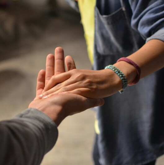 A person reaching out to help another person.