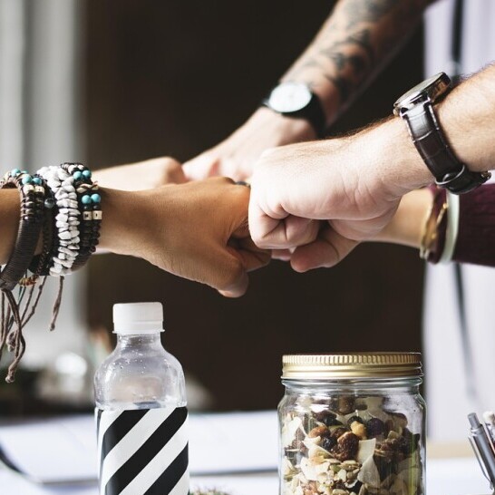 Family agreement. Several hands touching each other, showing teamwork.
