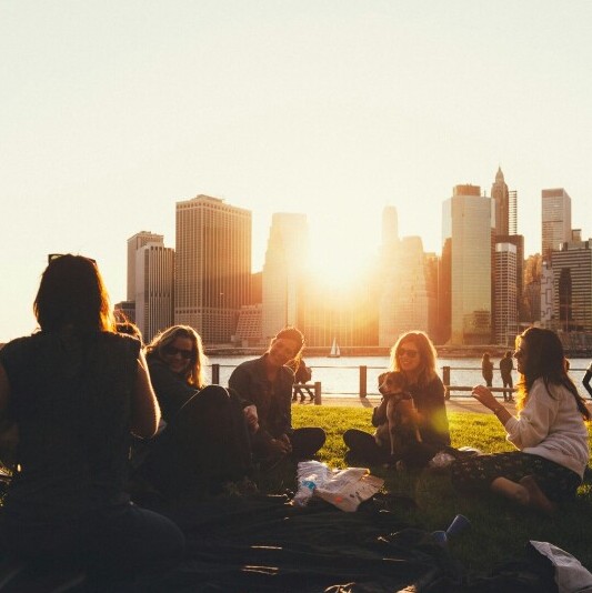 Friends talking sitting on the lawn in a park