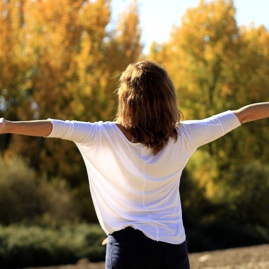 Woman practicing deep breathing exercises to reduce morning stress.